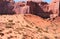 Iron oxide cross bedded sandstone cliffs overlook crescent dune below