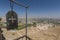 Iron plate with cross and panorama of the Valley of Jericho from Greek orthodox monastery of St. George on the Mount of Temptation