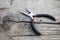 Iron pliers on a old rustic wooden table