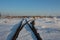 Iron rails the path for the train in the direction of freight covered with snow at the railway crossing in the winter
