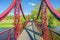 iron red suspension pedestrian bridge over the little river