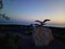 An iron sculpture dedicated to a pair of seagulls on the promenade in Novalja, on a stone plinth in Croatia