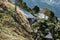 Iron sheds covering pedestrian roads of a hill with beautiful crop fields and mountains in the background