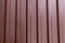 Iron sheet profile corrugated vertical parallel lines brown shiny base industrial background