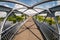 Iron steel frame construction of pedestrian bridge across the river. wide angle view