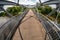 Iron steel frame construction of pedestrian bridge across the river. wide angle view