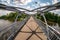 Iron steel frame construction of pedestrian bridge across the river. wide angle view