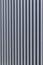 Iron structure with straight metal bars forming a striped structure on a wall