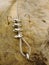 Iron twisted rope fixed in block by screws snaphooks. Detail of end of the anchored rope