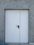 Iron white metal door in concrete wall