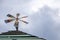 Iron wind turbine on the wooden roof before raining.