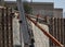 Iron workers on wall of rebar and steel beams on freeway construction project