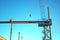 Ironworkers Fit-Up an I-Beam Suspended from Crane
