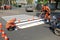 IRPIN, UKRAINE - MAY 06, 2017: Workers painting a pedestrian crosswalk. Machine for road marking paint