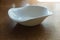 Irregular white porcelain dish on wooden table