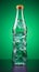 An irregularly shaped plastic soda or mineral bottle isolated on a vibrant studio backdrop