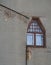 An irregularly shaped window in the wall of an old Moscow building