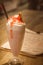 An irresistible duo of nutty and nice; peanut butter shake with strawberry jam and topped with whipped cream and a caramel biscuit