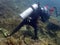 Irresponsibility underwater photographer whom step on the coral reefs during a leisure dive in Tunku Abdul Rahman Park, Sabah.