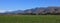 Irrigated green meadow and dry mountains