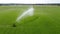 Irrigating meadow in the summer