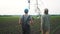 irrigation agriculture. two silhouette farmers working in the field examining installation for irrigating lifestyle corn