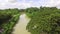 Irrigation canal murky water flowing in small farming community village.