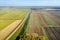 An irrigation canal separates the fields