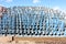 Irrigation pipes, blue colored, stacked on each other, blue sky