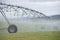 Irrigation by Pivot sprinkler on grass field