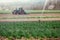 Irrigation plant system on a field, agriculture. Tractor in the blurry background