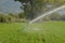 Irrigation splashing water in a corn field  reel hose