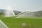 Irrigation splashing water in a corn field  reel hose