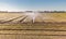 Irrigation system on a large farm field. Water sprinkler installation