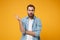 Irritated bewildered young bearded man in casual blue shirt posing isolated on yellow orange background, studio portrait