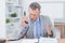 Irritated businessman answering phone