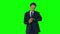 Irritated businessman checking time on green screen