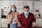 Irritated couple in medical masks screaming