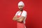 Irritated young bearded male chef cook baker man in striped apron white t-shirt toque chefs hat posing isolated on red