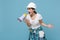 Irritated young woman in protective helmet hardhat scream in megaphone isolated on blue background studio. Instruments