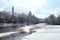 Isar river flows among the cold white landscape of the city of Munich in the snow, a park in winter, the concept of seasonal