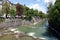 Isar river  with a lot of tree trunks stuck in the rapids in Munich