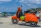 Ischia, Italy - June 20, 2018: Vintage orange Vespa scooter park