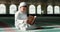 Islam, boy in mosque reading Quran for learning mindfulness and gratitude in faith with kids prayer. Worship, religion