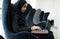 Islamic girl sitting and using laptop