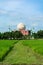 Islamic muslim Mosque against backdrop of blue sky and rice field. Mosque in Bangladesh