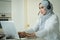 Islamic Muslim wife work from home, at the kitchen table