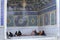 Islamic pilgrims group resting in outer recess of mosque, Iran.