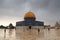 Islamic shrine Dome of the Rock with gold leaf and dark clouds on Temple Mount in Jerusalem Old City, Israel