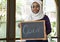 Islamic woman small business owner holding blackboard with smiling